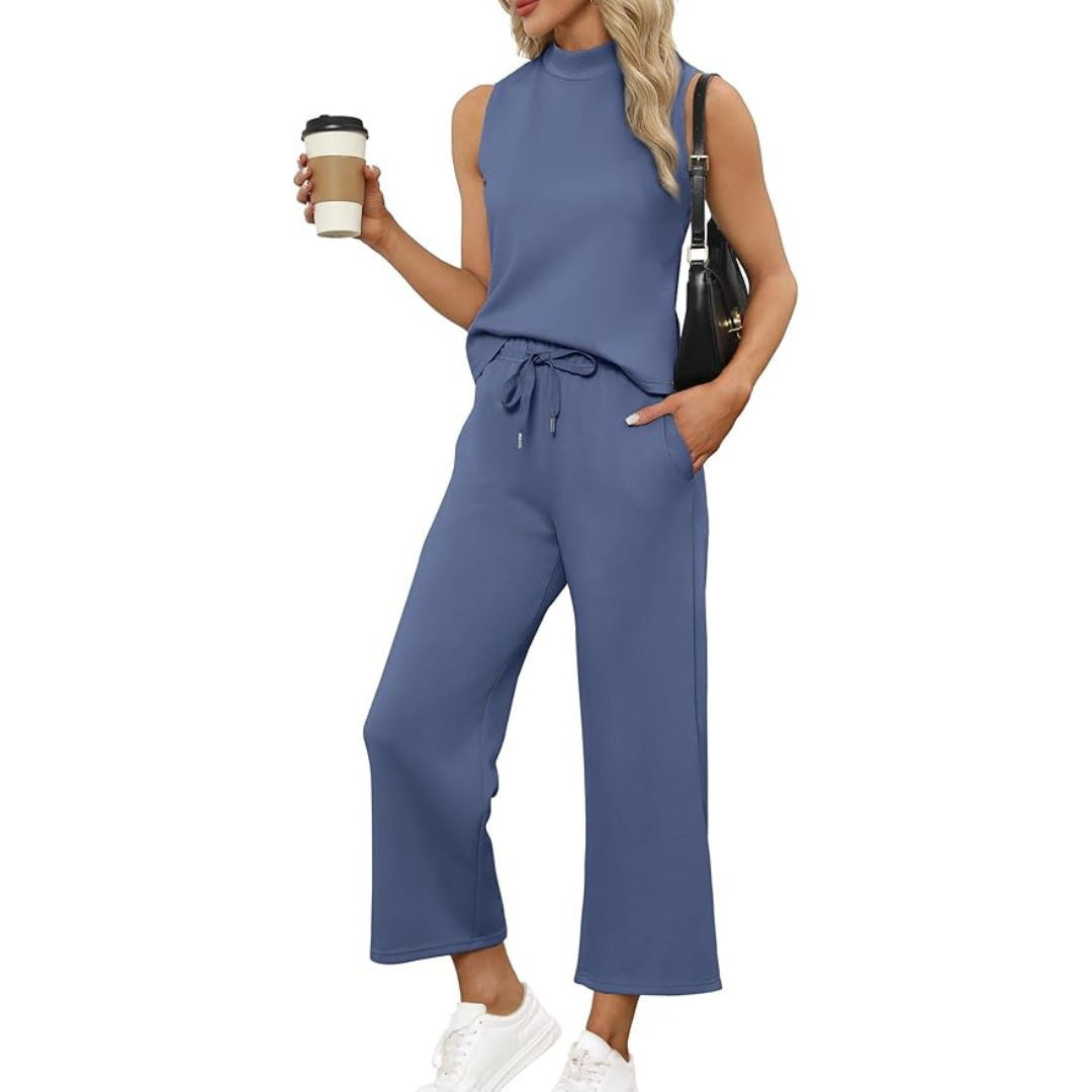 Blue two-piece sleeveless mock neck lounge set with wide-leg pants styled casually with white sneakers and a coffee cup.