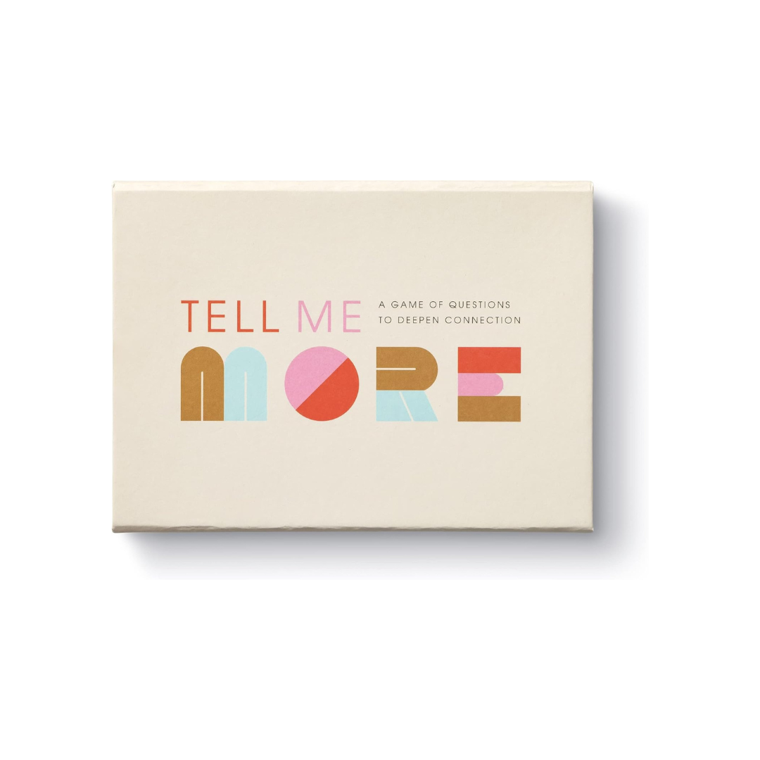 A cream box with fun colored letters "Tell Me More: A Conversation Starter Game"