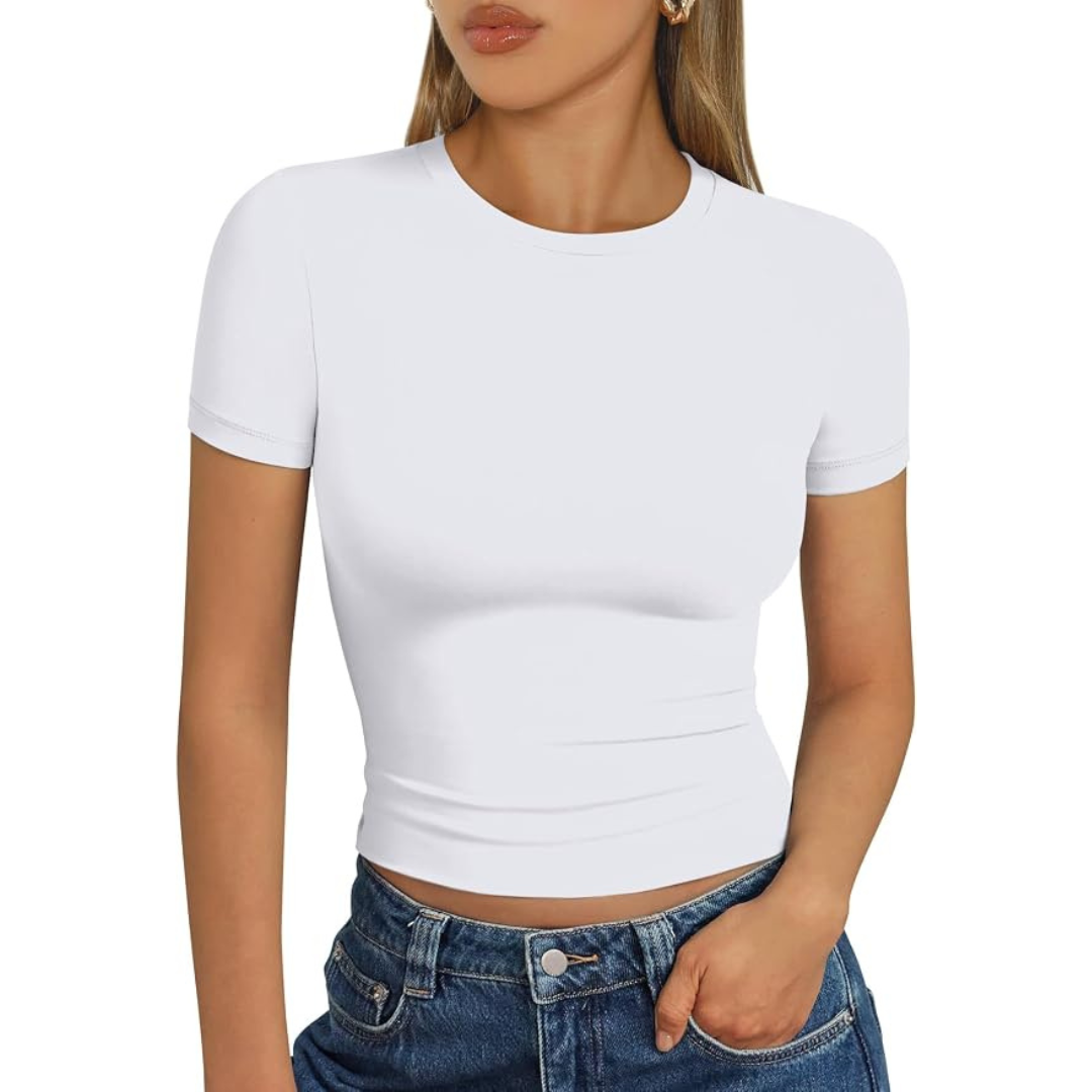 Woman wearing a fitted white short-sleeve crewneck T-shirt with blue jeans.