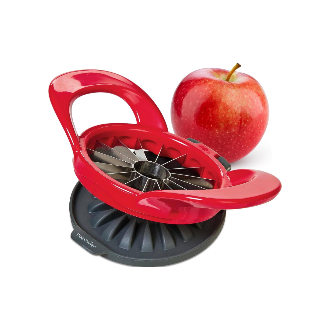 Red Progressive Prepworks apple slicer with stainless steel blades displayed beside a red apple.