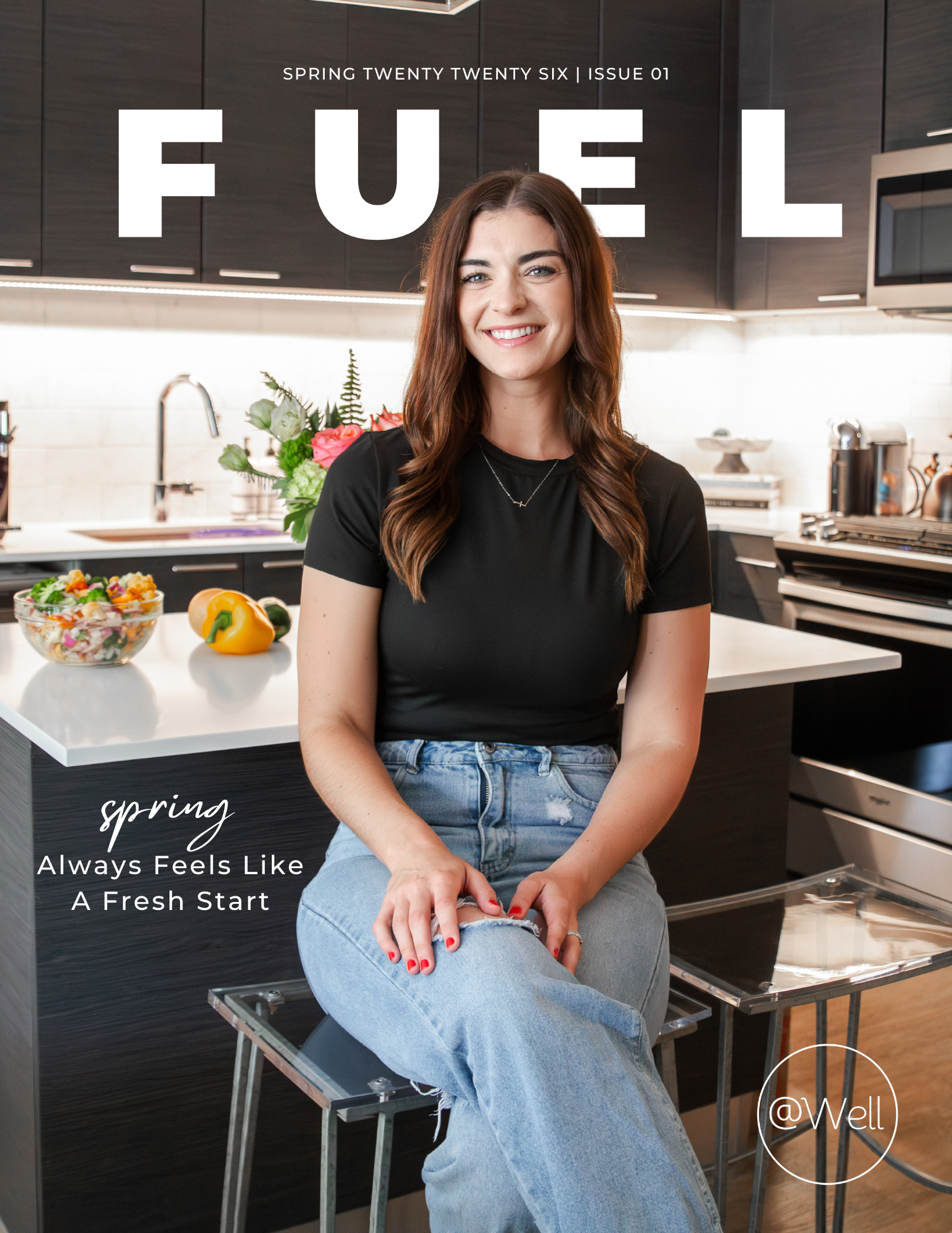Woman sitting in a modern kitchen with fresh ingredients, promoting Fuel Spring Edition recipe guide for meal planning and balanced nutrition