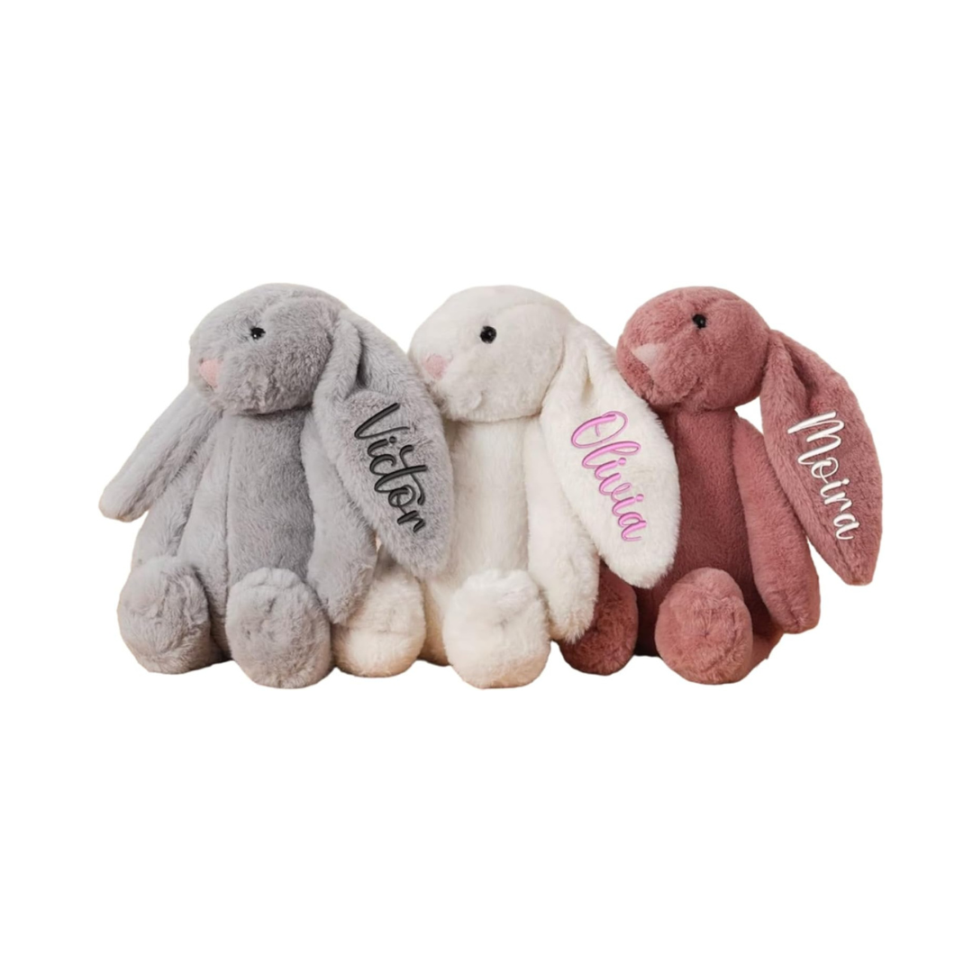 Grey, White, and Brown plush bunnies with embroidered names on their ears.
