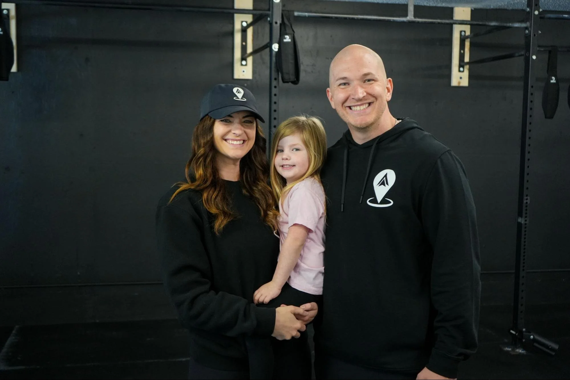 Gym owners and family at Anywhere Fitness during grand opening, representing community, connection, and in-person fitness support
