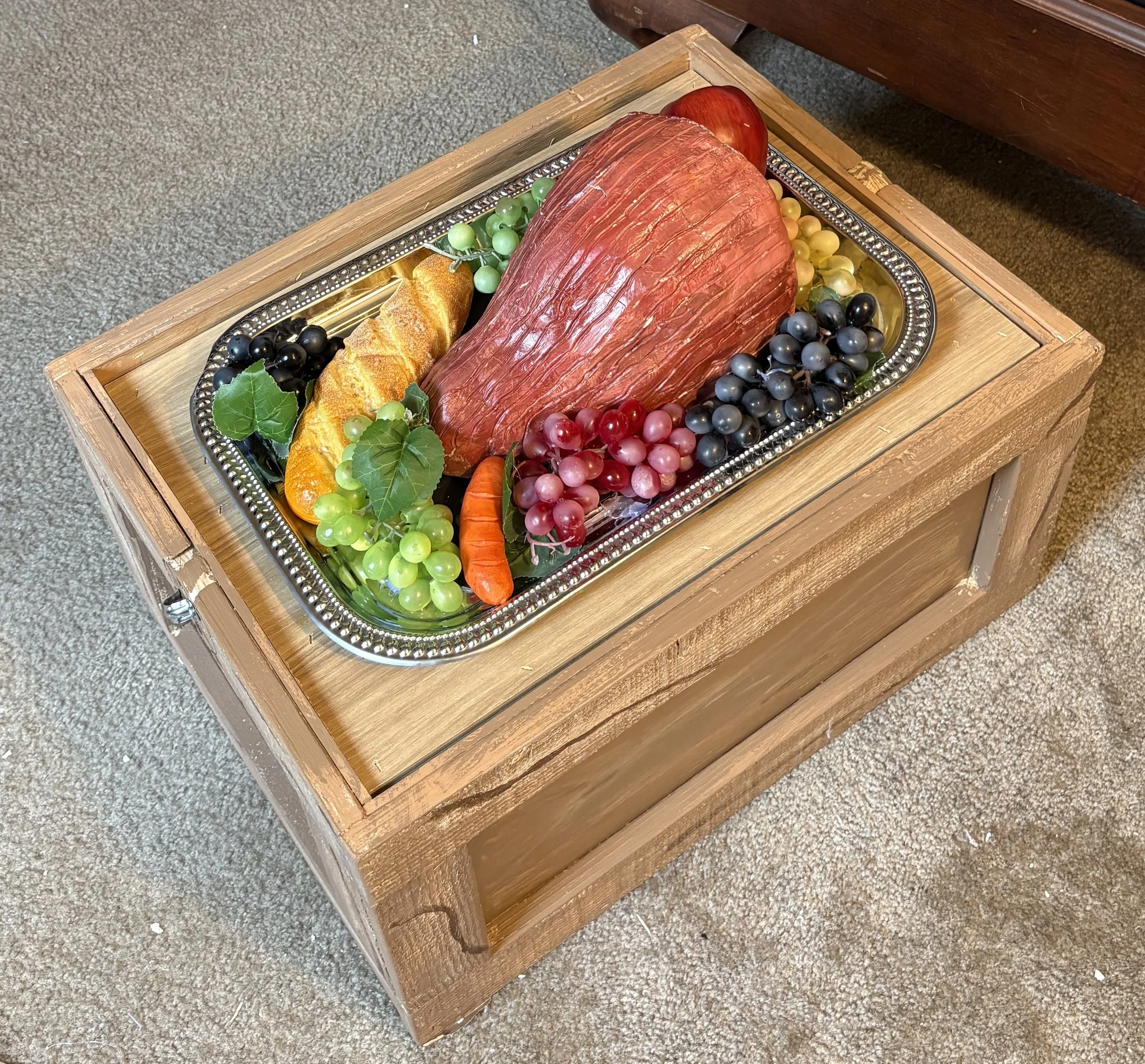 For The Tempest, we needed a disappearing feast, so the director and I came up with the idea of having the feast in a crate with a flipable lid. lid. For this, I constructed a box to look like other crates in the set. I made the lid flipable by gluin