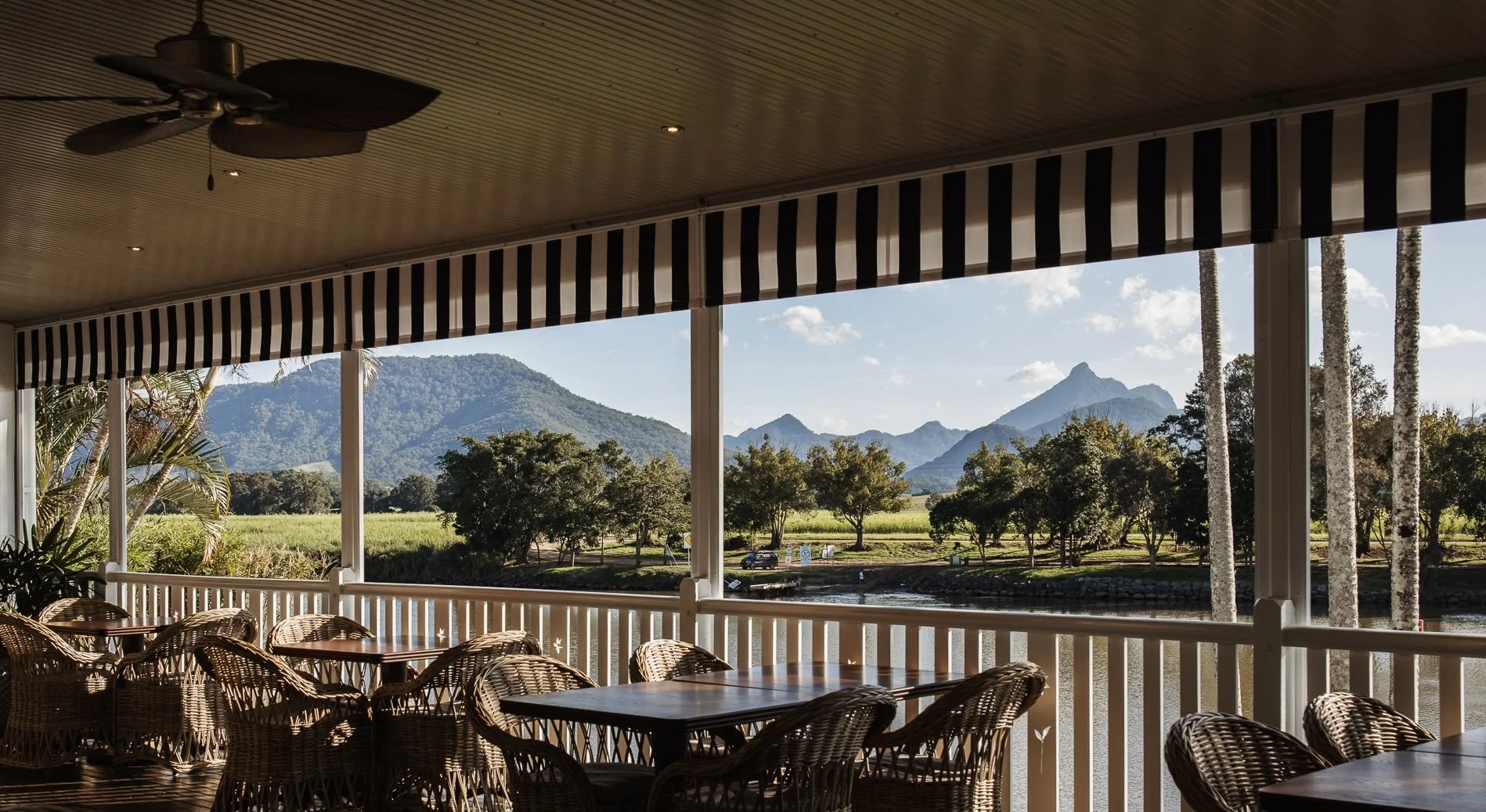 Patio with wicker furniture overlooking scenic mountain landscape