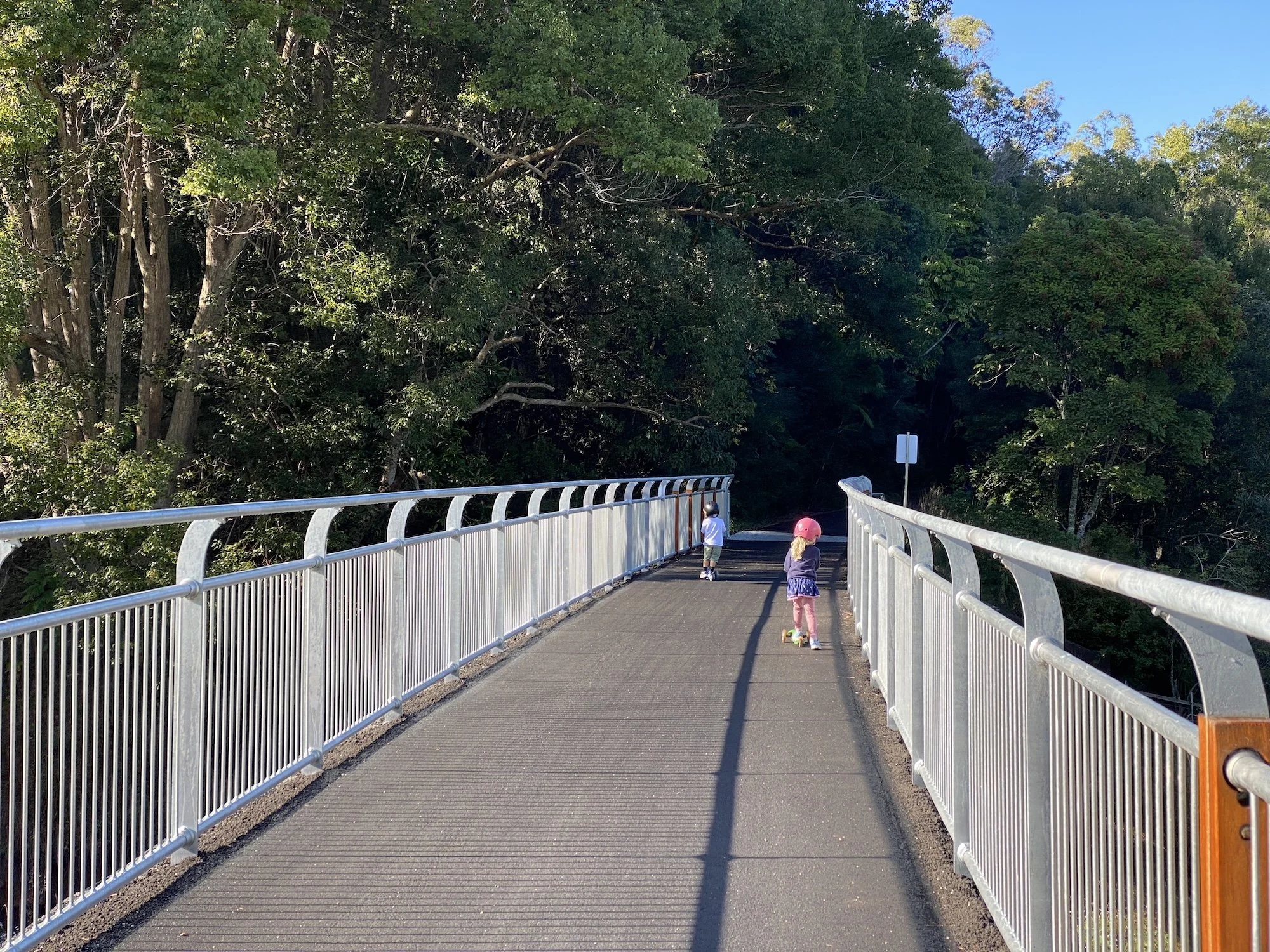 Kids riding scooters on the Northern Rivers Rail Trail