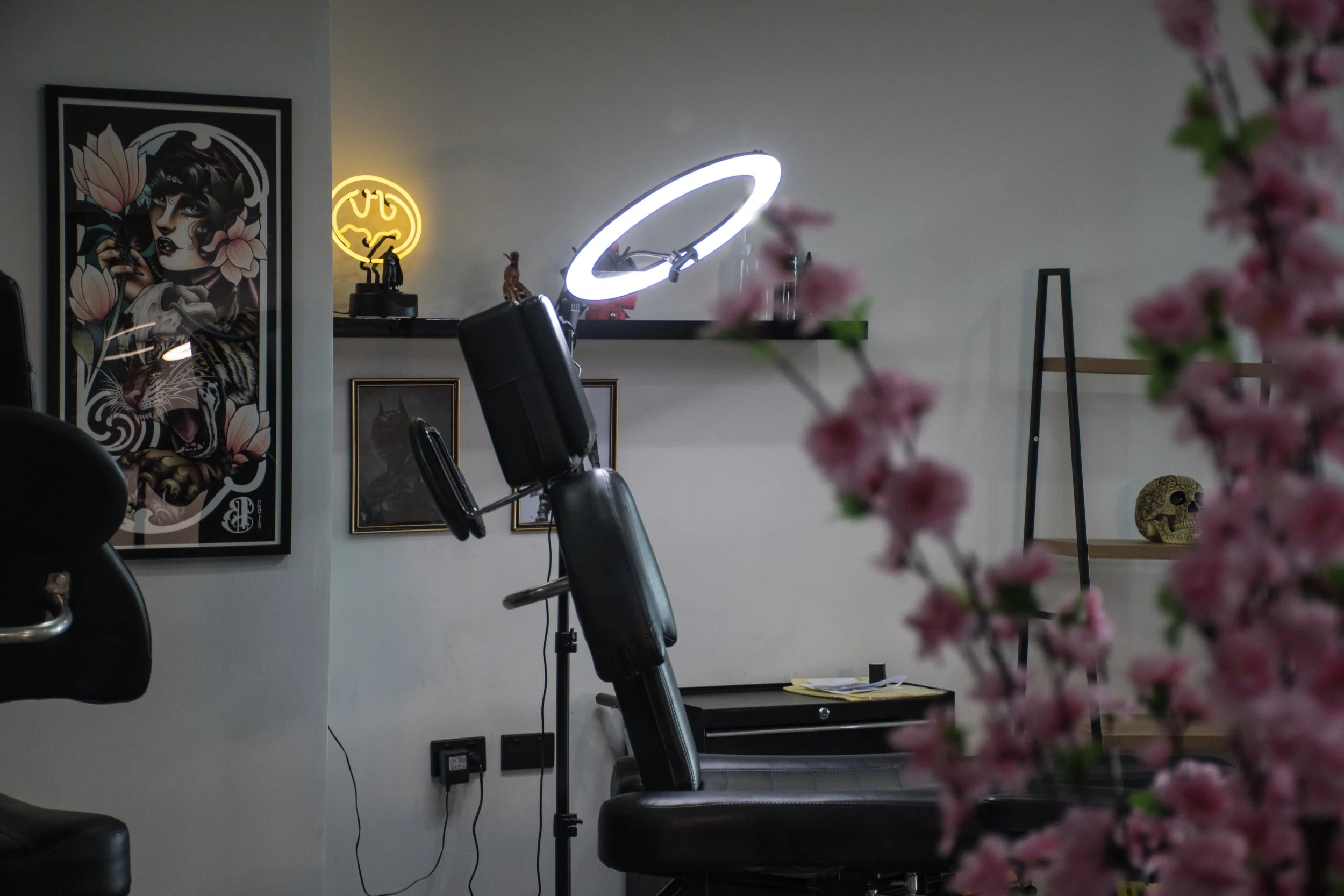 A close up picture of a tattoo artists station at Inkdulgence Tattoo Studio Adelaide. Featuring cherry blossoms and art work on the walls.