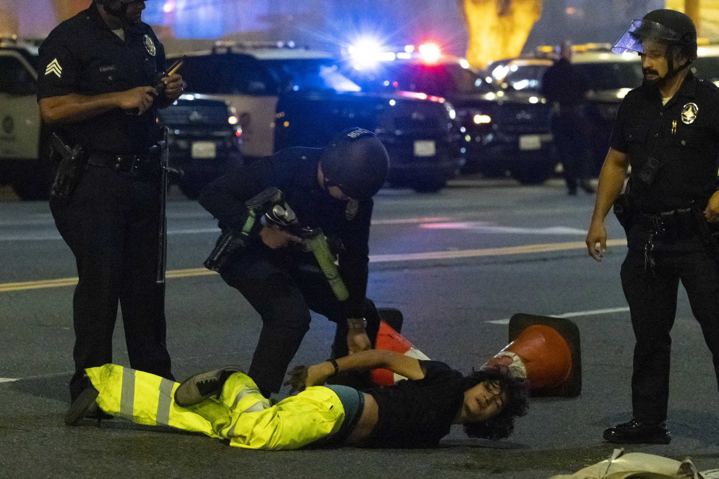 A skateboarder is arrested after crashing into a Los Angeles Police Department skirmish line during the Halloween Hellbomb event hosted by Thrasher, Vans, and Monster Energy on Saturday, Oct. 25, 2025, in downtown Los Angeles. The event was declared 