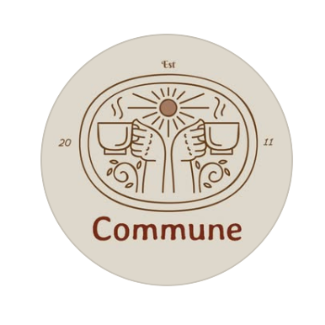 A round logo featuring two hands holding coffee mugs with steam, a sun above, and the word "Commune" below. The logo includes the year 2011 and the word "Est" at the top.