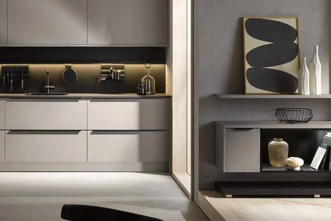 Sleek beige kitchen with under-cabinet lighting and minimalistic decor accents