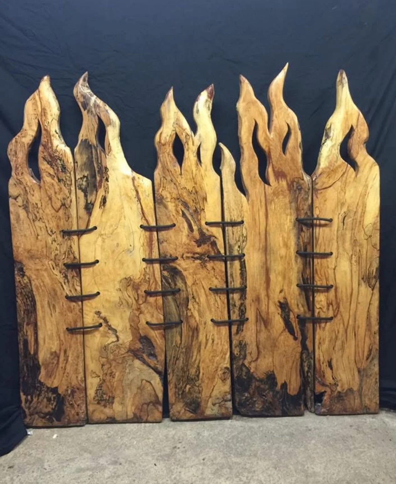 Collection of rustic wooden cutting boards with unique shapes and natural wood grain against a neutral background.