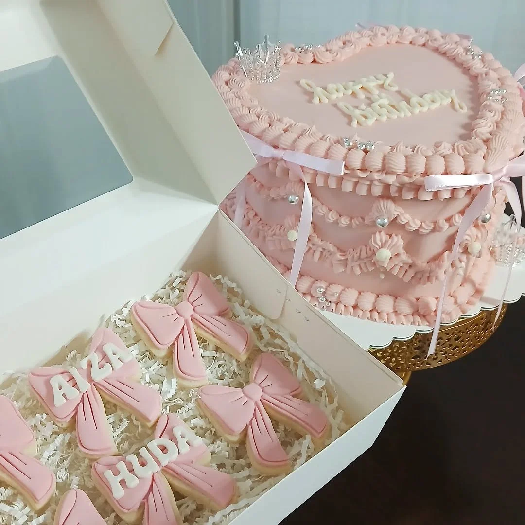 Happy Birthday Aiza &amp; Huda! 🎀👑

This is our 10&quot; heart cake with 3 layers of cake and delicious filling - the cutest way to serve a small crowd! 💕 

Their design includes detailed vintage piping, shiny silver pearl sprinkles, long pink sat