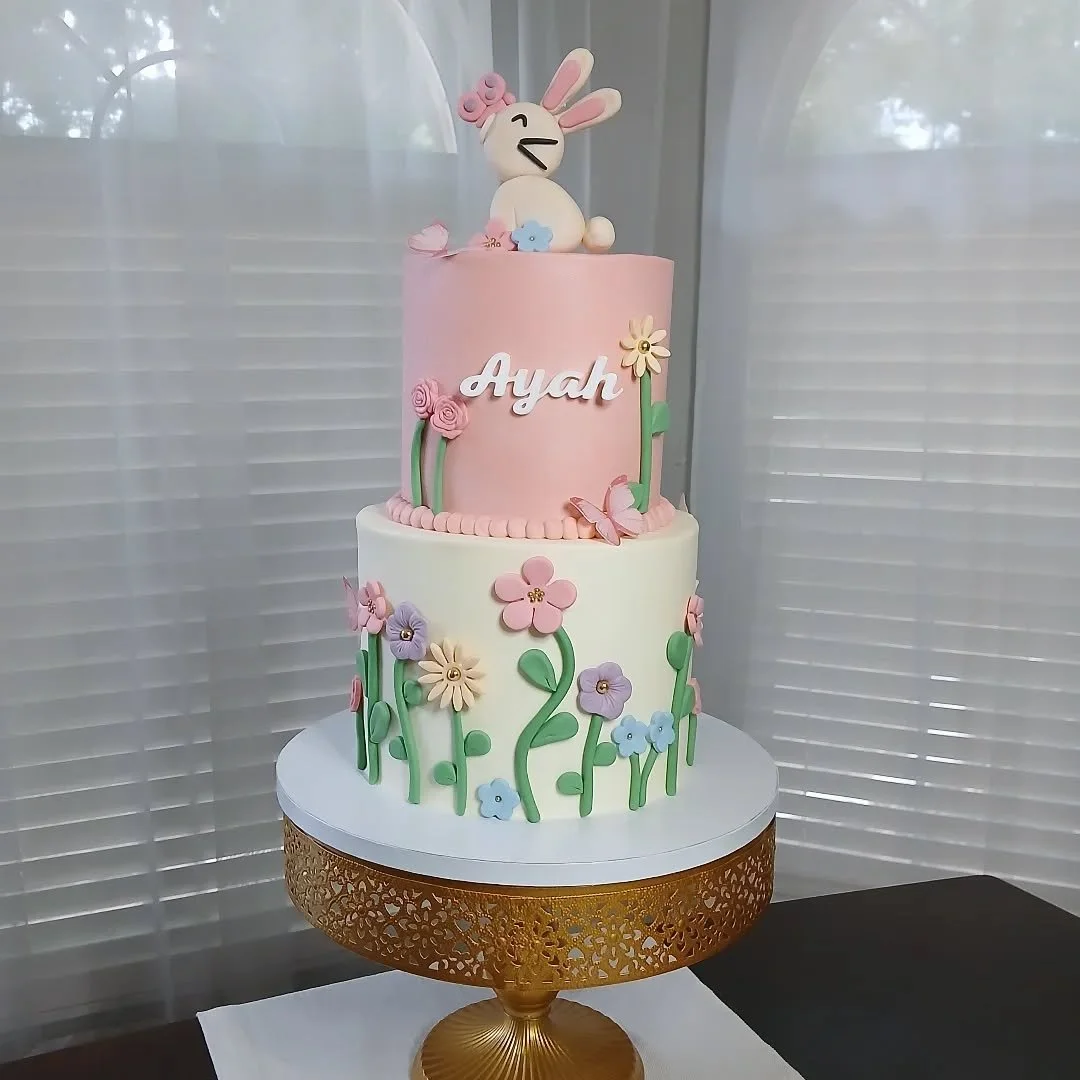 Hoppy 1st Birthday, Ayah! 🐰 

I am so so obsessed with the theme for this celebration: Some Bunny is One! 🐇🌸🏵

This 2 tier cake had 3 layers of 6&quot; vanilla cake with a caramel filling and 3 layers of 8&quot; chocolate cake with a chocolate mo