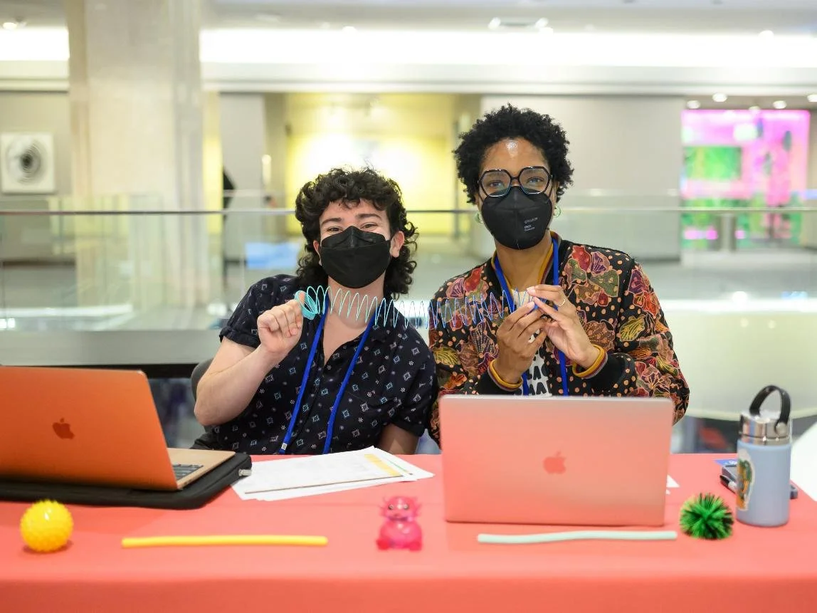 A white person and black person both wearing masks with dark hair at last year's convening in the Twin Cities.