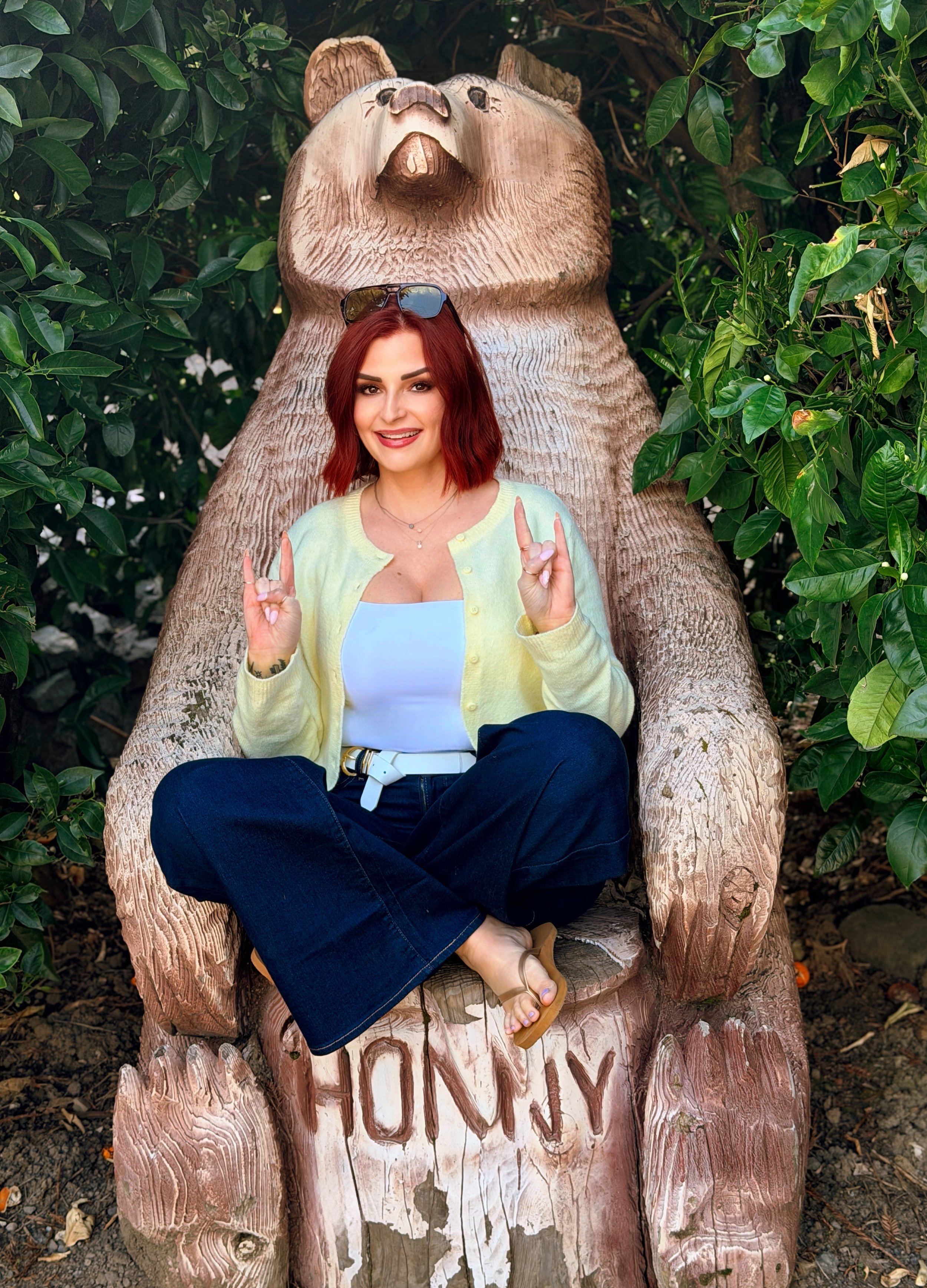 a red headed girl sitting in a bear with rock signs