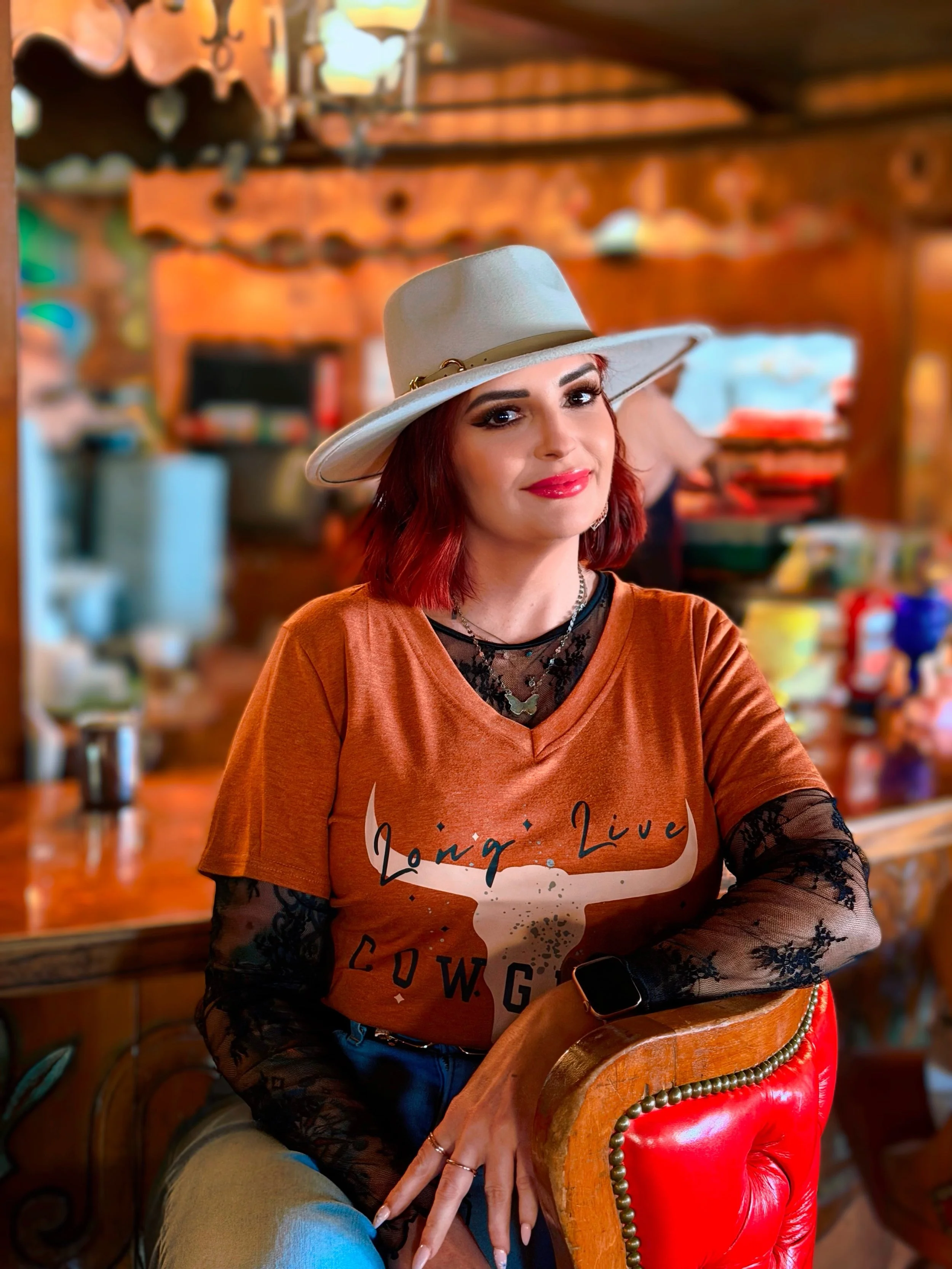 a girl with a hat and orange shirt