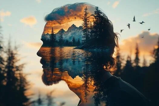 Image of mans head with mountains and water with orange and blue colors