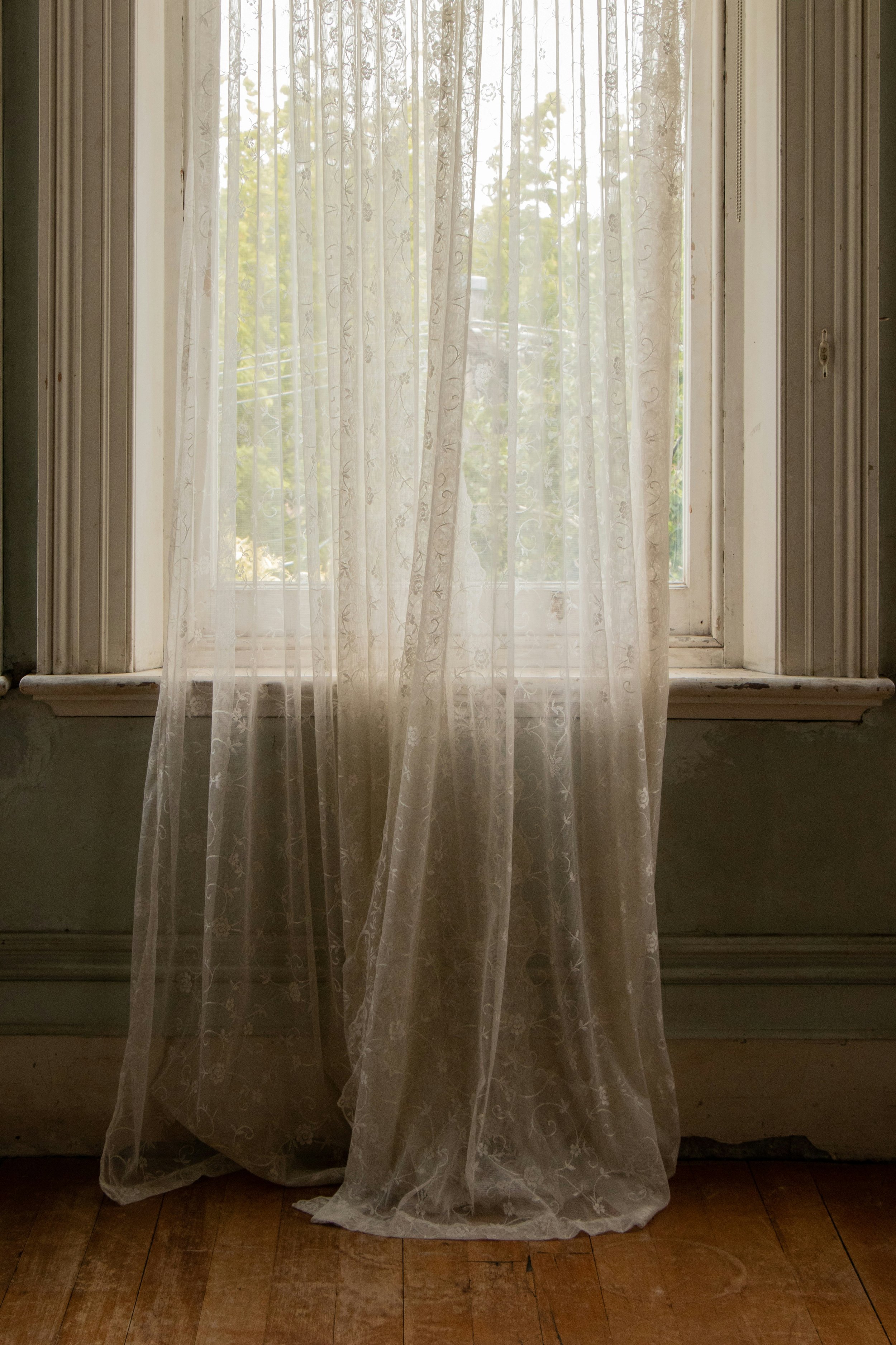 Soft natural light filtering through sheer curtains in a calm interior space.