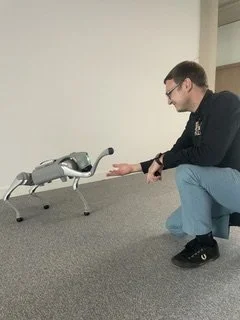 Man shaking hands with robot dog