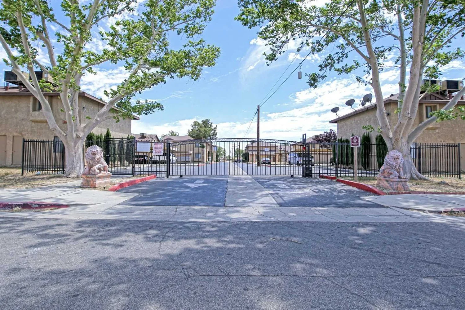 This image includes the street-view of the apartment complex that is gated. 