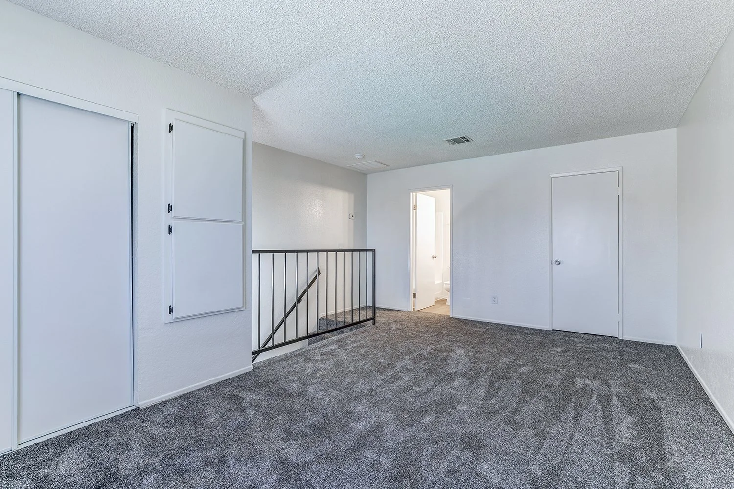 This image shows the upstairs portion of the apartment with a sliding closet and two doors. 