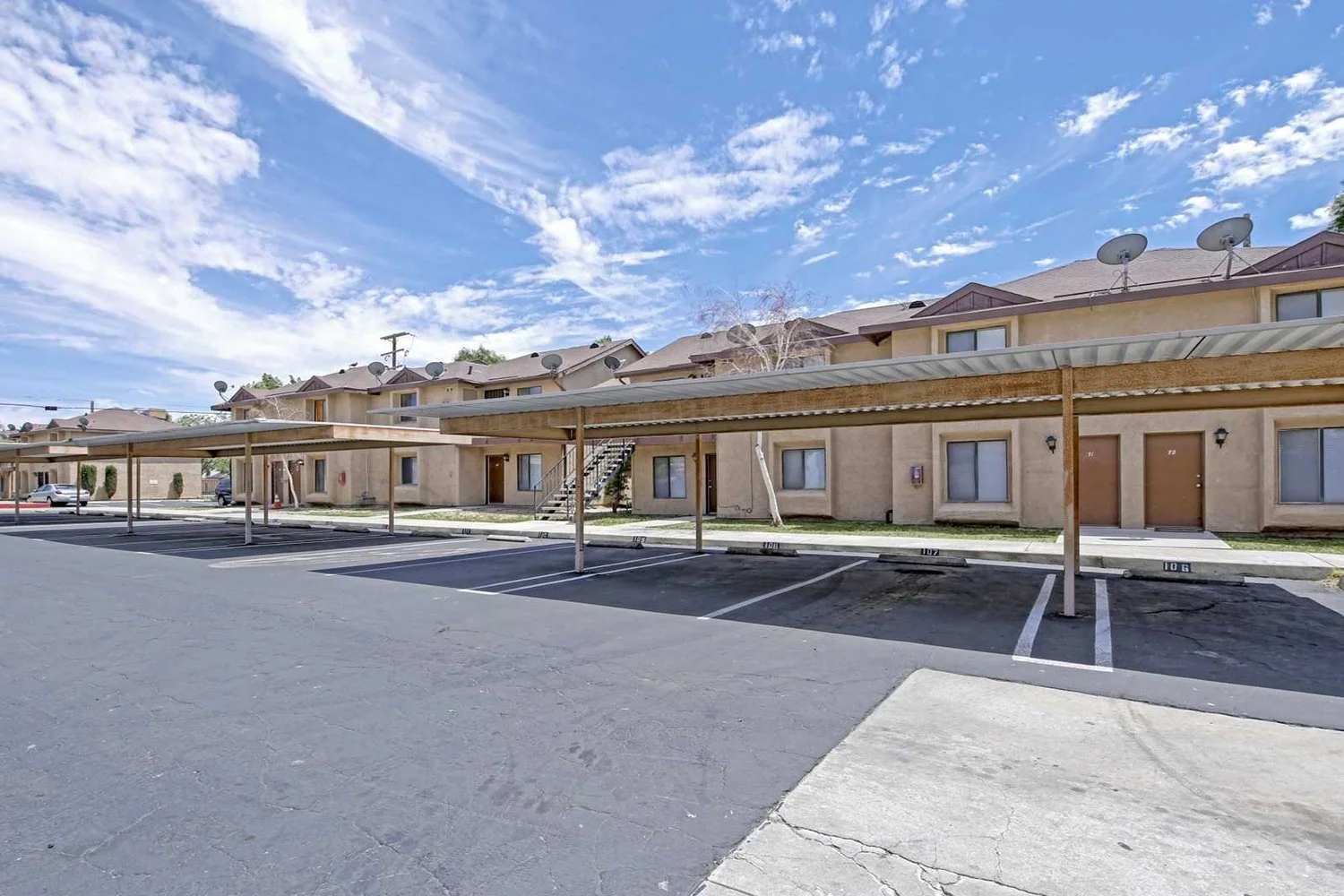 Another angle that shows the parking lot with awnings to cover the cars with the buildings in the background.