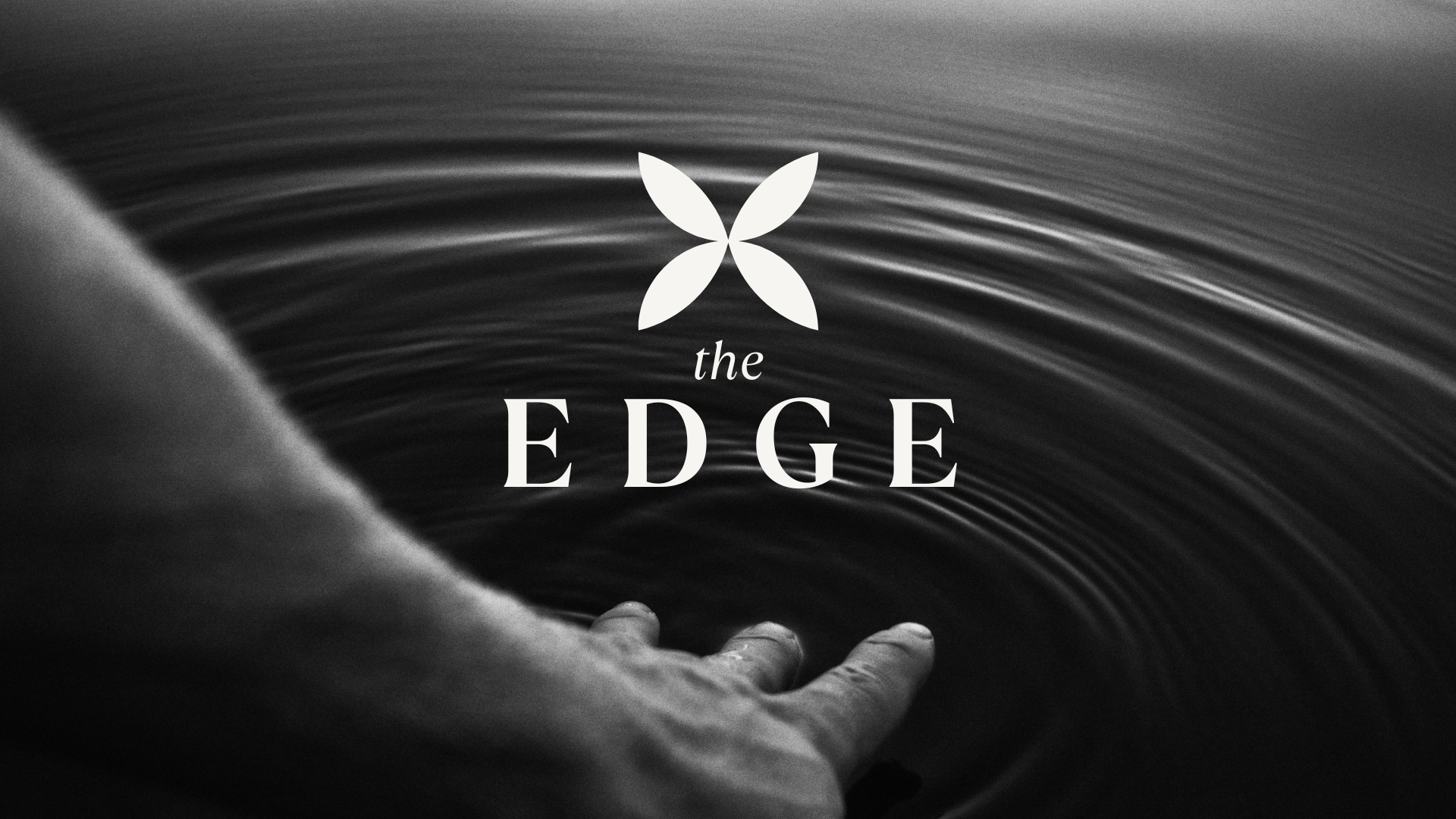 The EDGE program image showing a hand interacting with rippling water, representing embodied awareness and transformation.