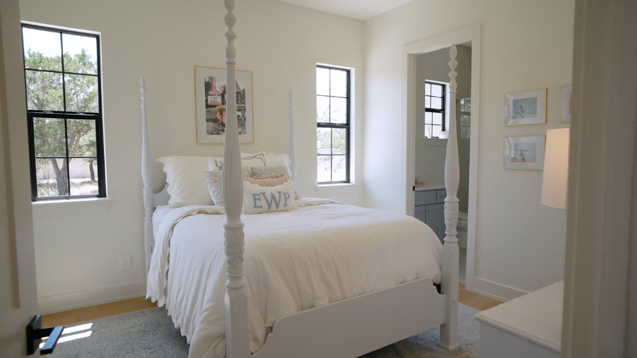 Guest bedroom with four-poster bed in a Texas Hill Country home, with Texas Living Homes in Fredericksburg, Texas and the Texas Hill Country
