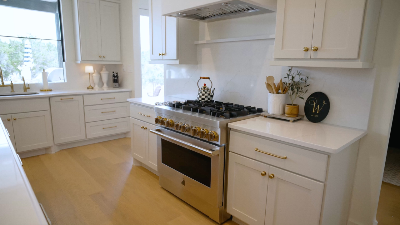 Gas range with brass knobs in Texas Hill Country custom homes, with Texas Living Homes in Fredericksburg, Texas and the Texas Hill Country