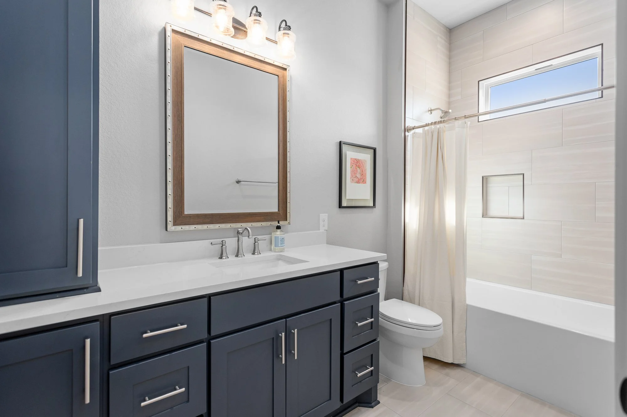 Texas Living Homes - Timeless elegance in this Fredericksburg home with blue custom cabinetry and warm wood accents.