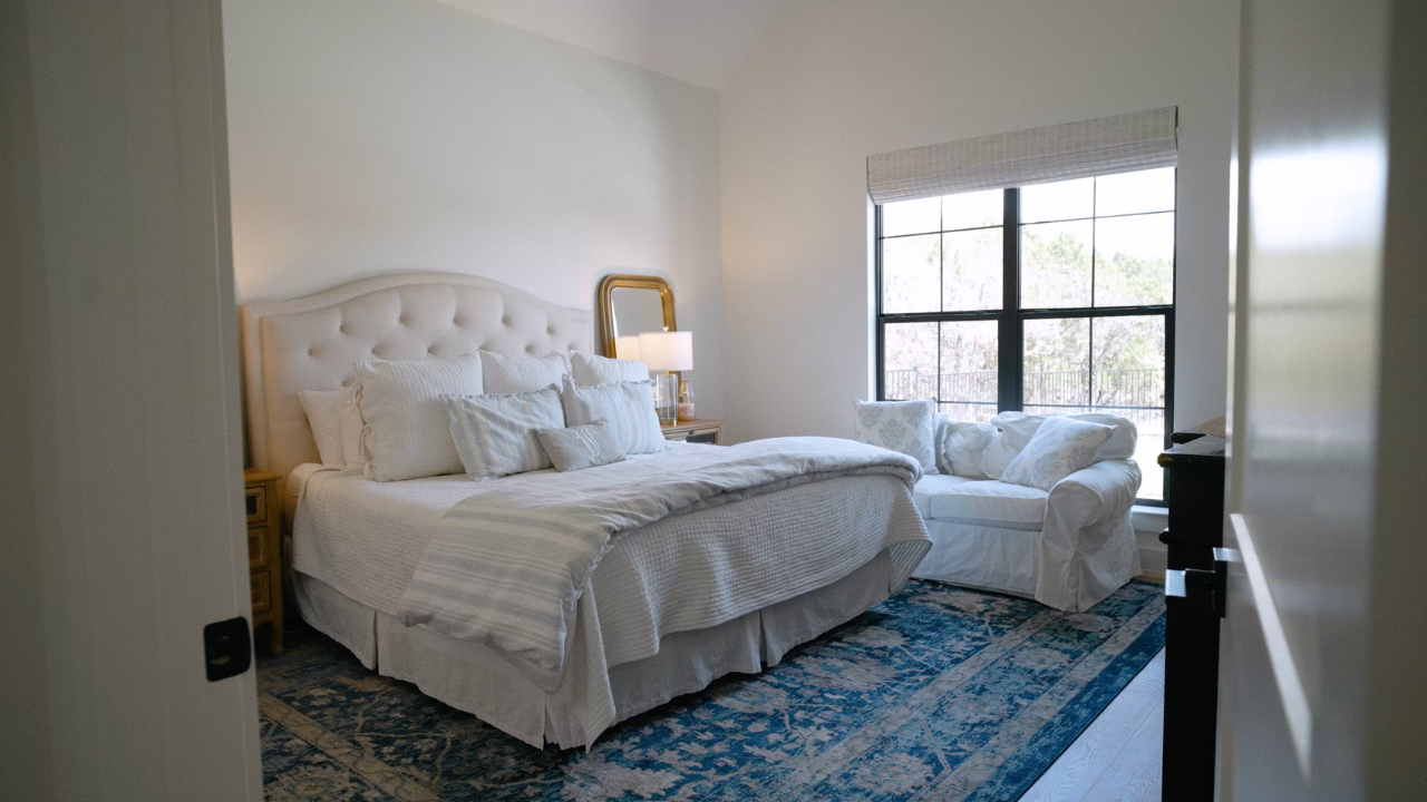 Primary bedroom with tufted headboard by Kerrville home builders, with Texas Living Homes in Fredericksburg, Texas and the Texas Hill Country