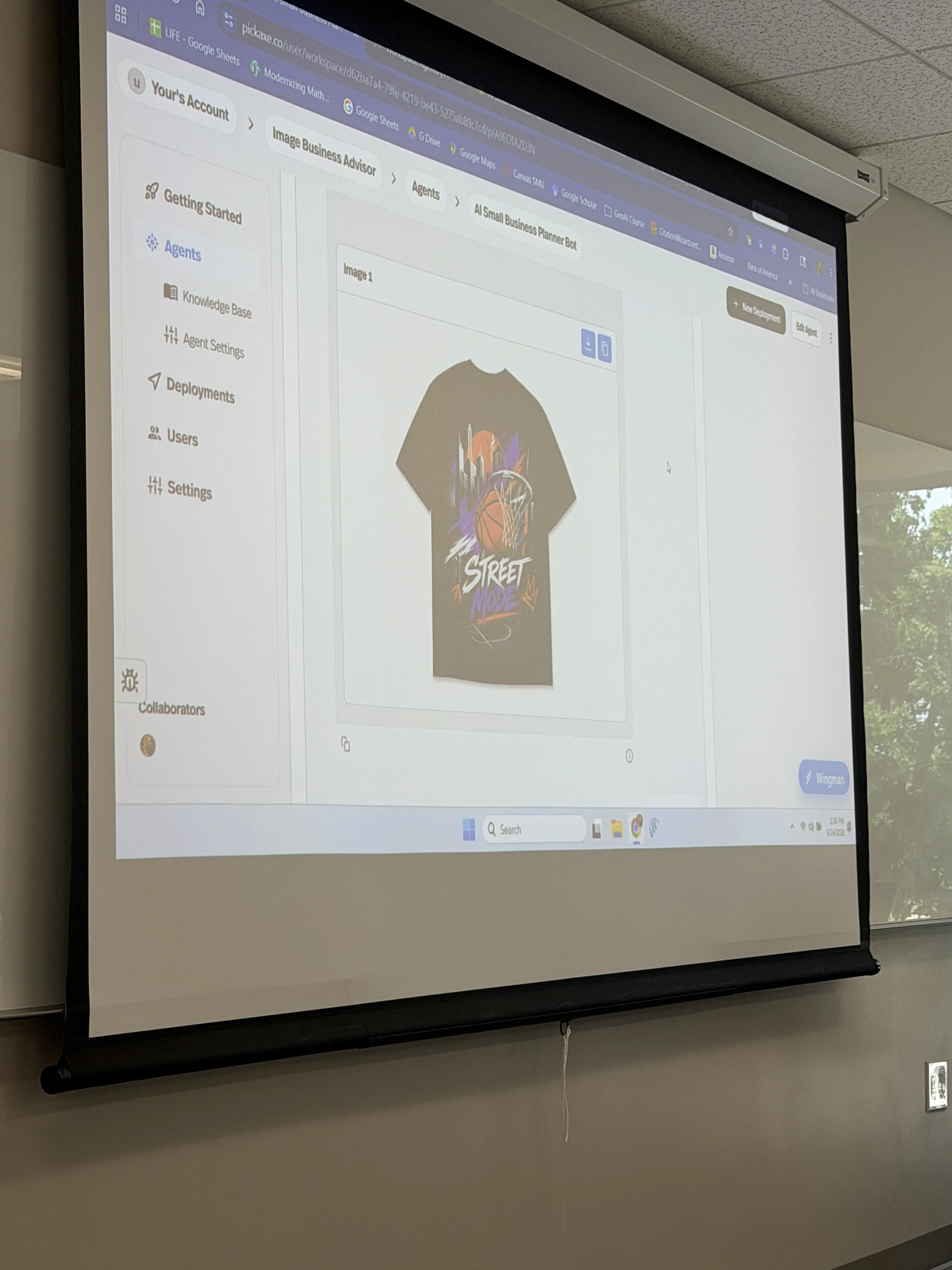 Projection screen displaying a webpage with an interface for creating custom t-shirt designs, featuring a shirt graphic with colorful graffiti-style artwork and text that reads 'STREET MODE'.