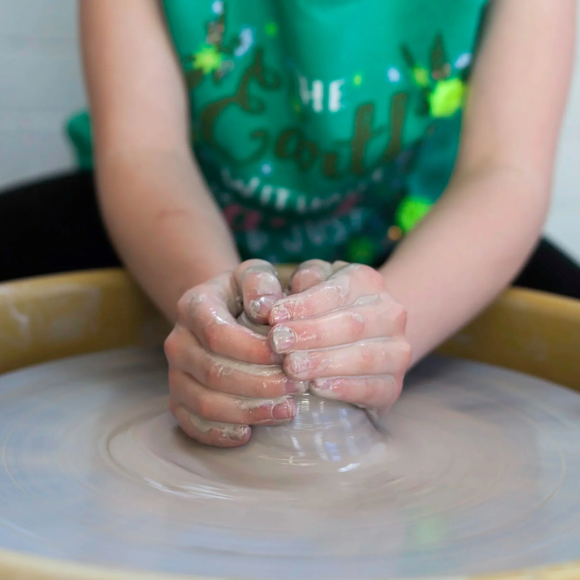Child Using Pottery Wheel