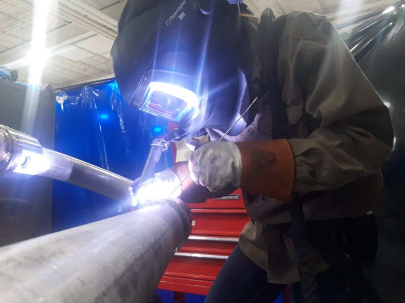  A welding student welding a sculpture in the Metal Studio at Groundworks Art Lab in Boulder, CO. 