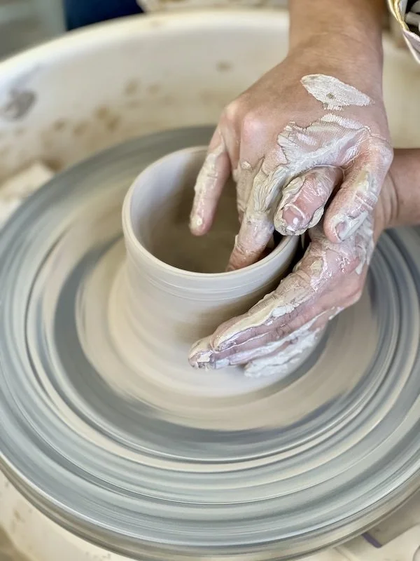 An older teen works on throwing a clay vessel on the pottery wheel in Groundworks Art Lab's new Older Teen Wheel class.