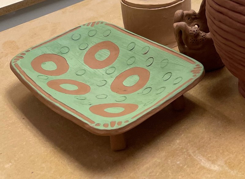 A hand-built ceramic tray decorated with slip in a geometric design. Learn how to make your own stencils to decorate your pottery in the Stencil Design class at Groundworks Art Lab in Boulder, CO.