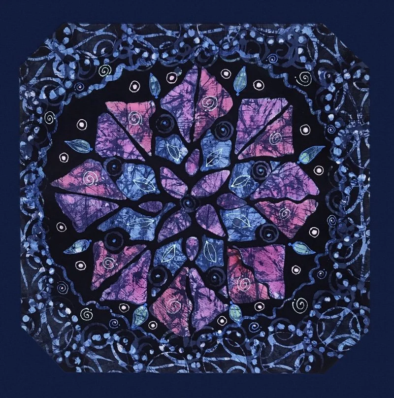 A blue and purple batik mandala design printed on blue fabric