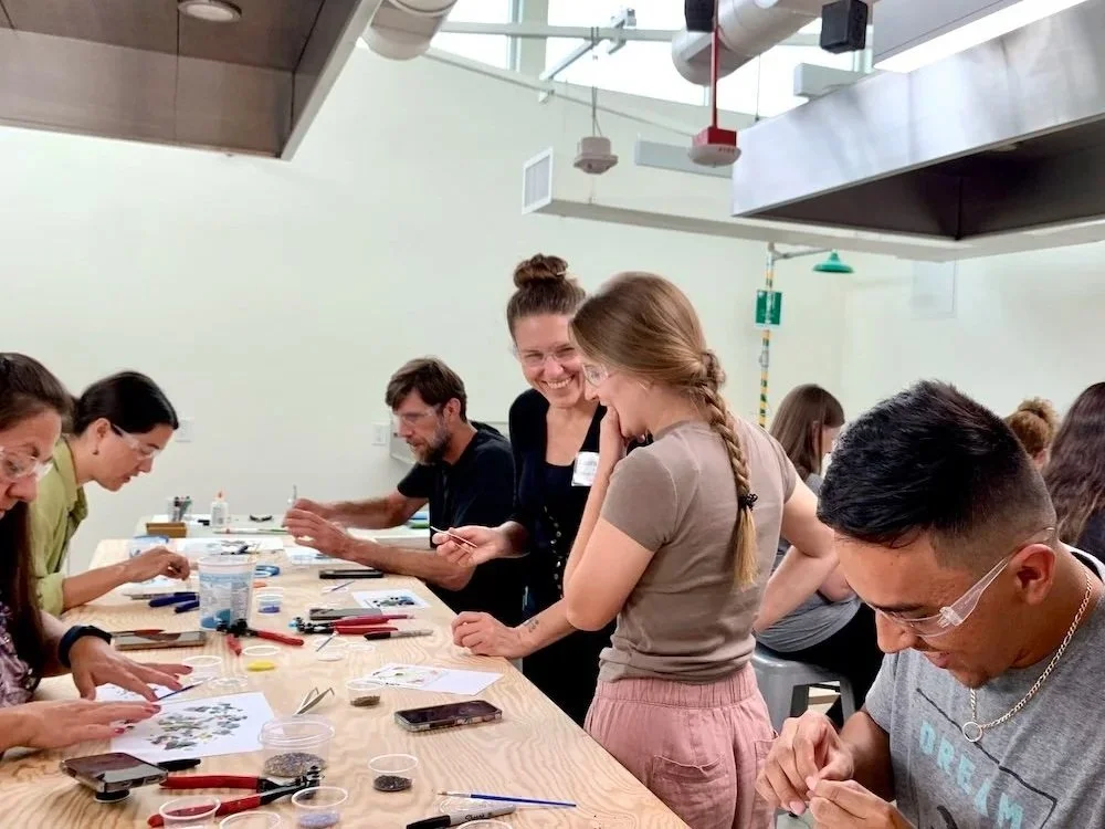 An instructor and student laughing and talking during a class in the Glass Studio at Groundworks Art Lab in Boulder, CO.