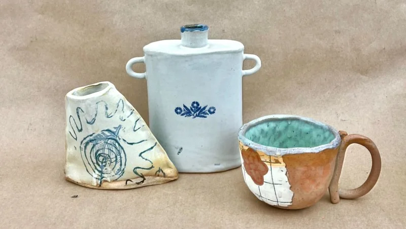 Three handmade ceramic vessels with custom underglaze designs.