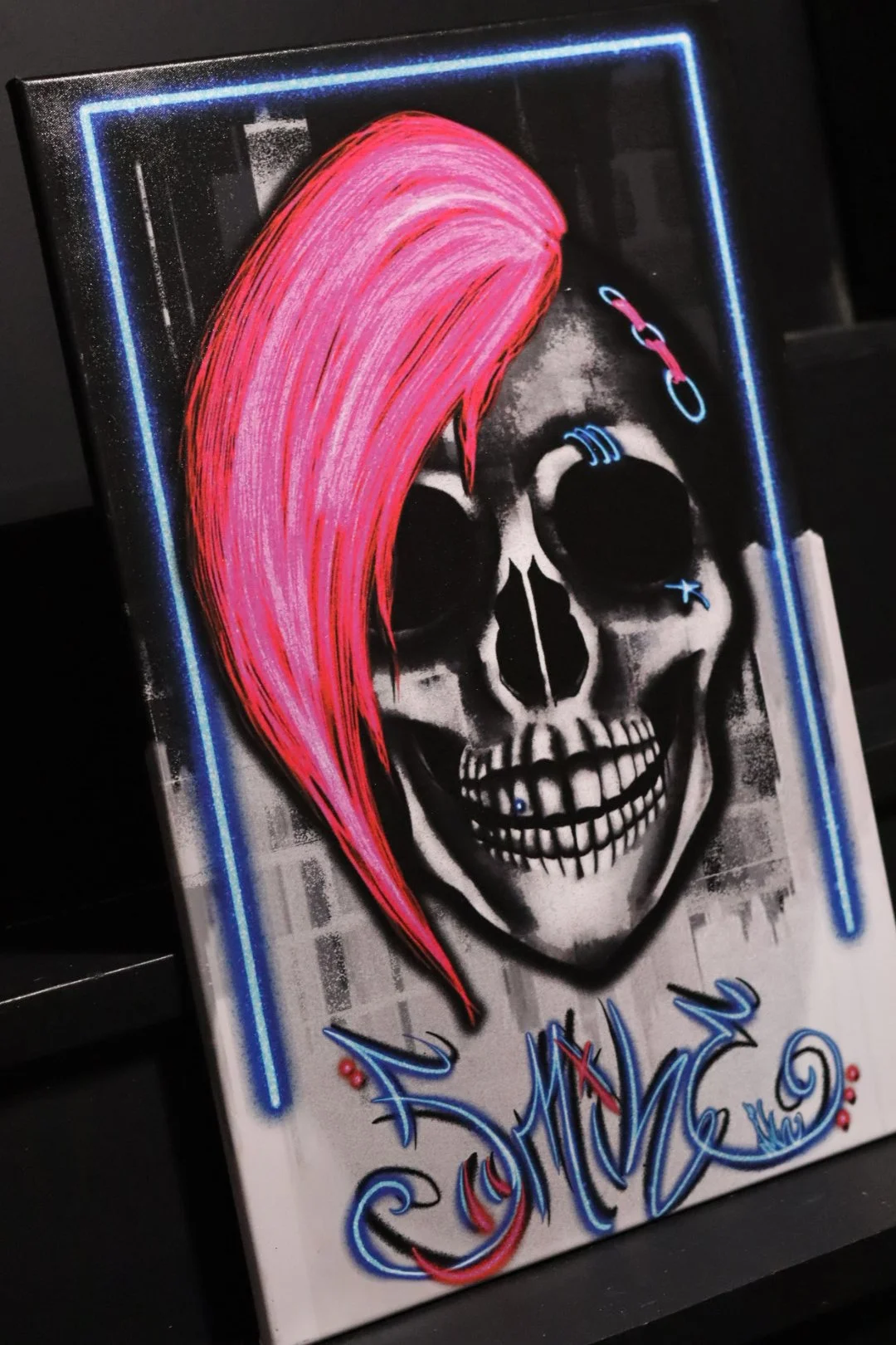 Graffiti punk rock style original fine art canvas featuring a skull with neon pink hair and style writing Smile in neon lettering from Edmond, Oklahoma artist and graffiti writer AWE_Graffiti
