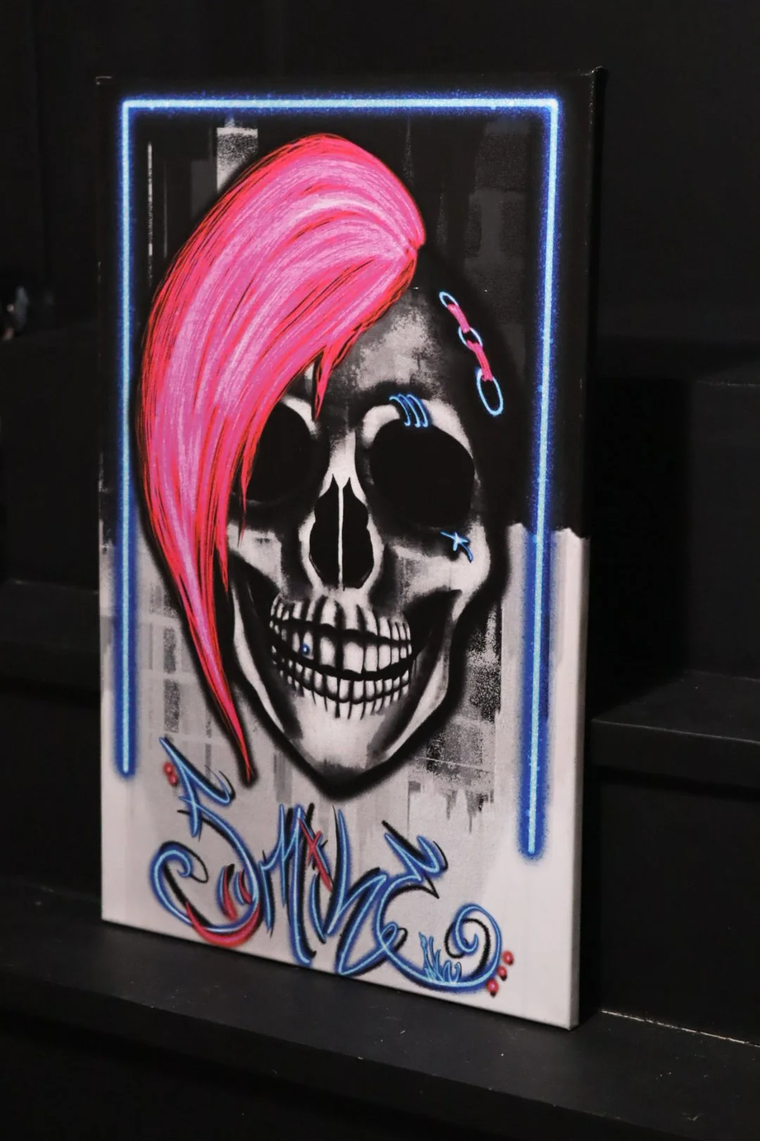 Graffiti punk rock style original fine art canvas featuring a skull with neon pink hair and style writing Smile in neon lettering from Edmond, Oklahoma artist and graffiti writer AWE_Graffiti