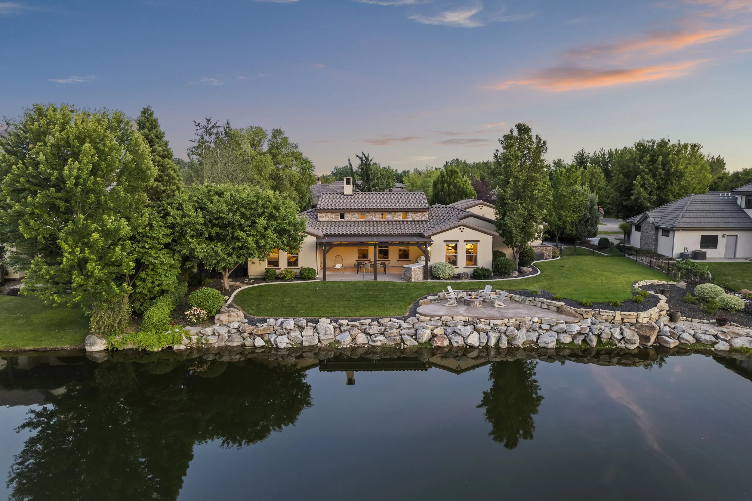 Aerial twilight view of a waterfront luxury home in The Shores Community in Eagle, Idaho