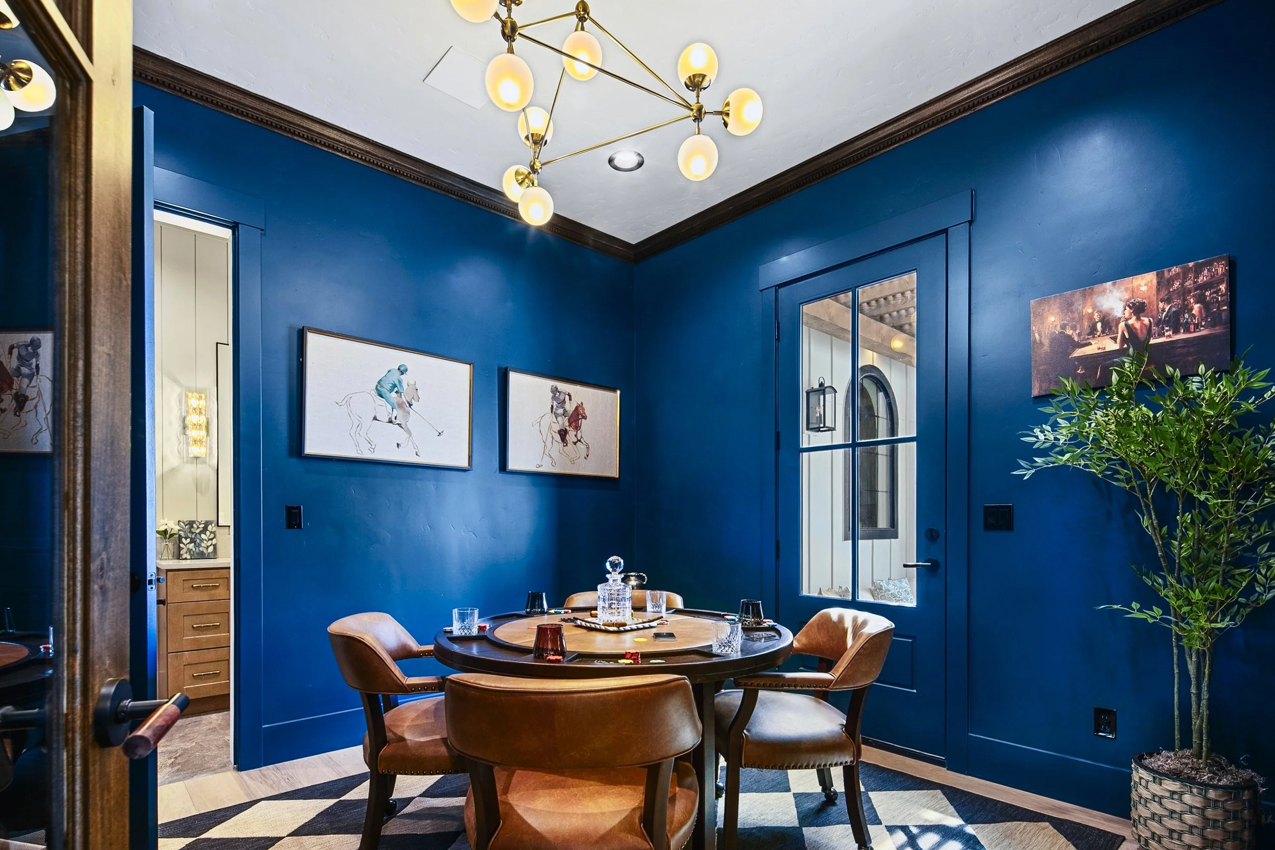 Moody blue dining room with brass chandelier in an Eagle, Idaho luxury home - located in Valnova