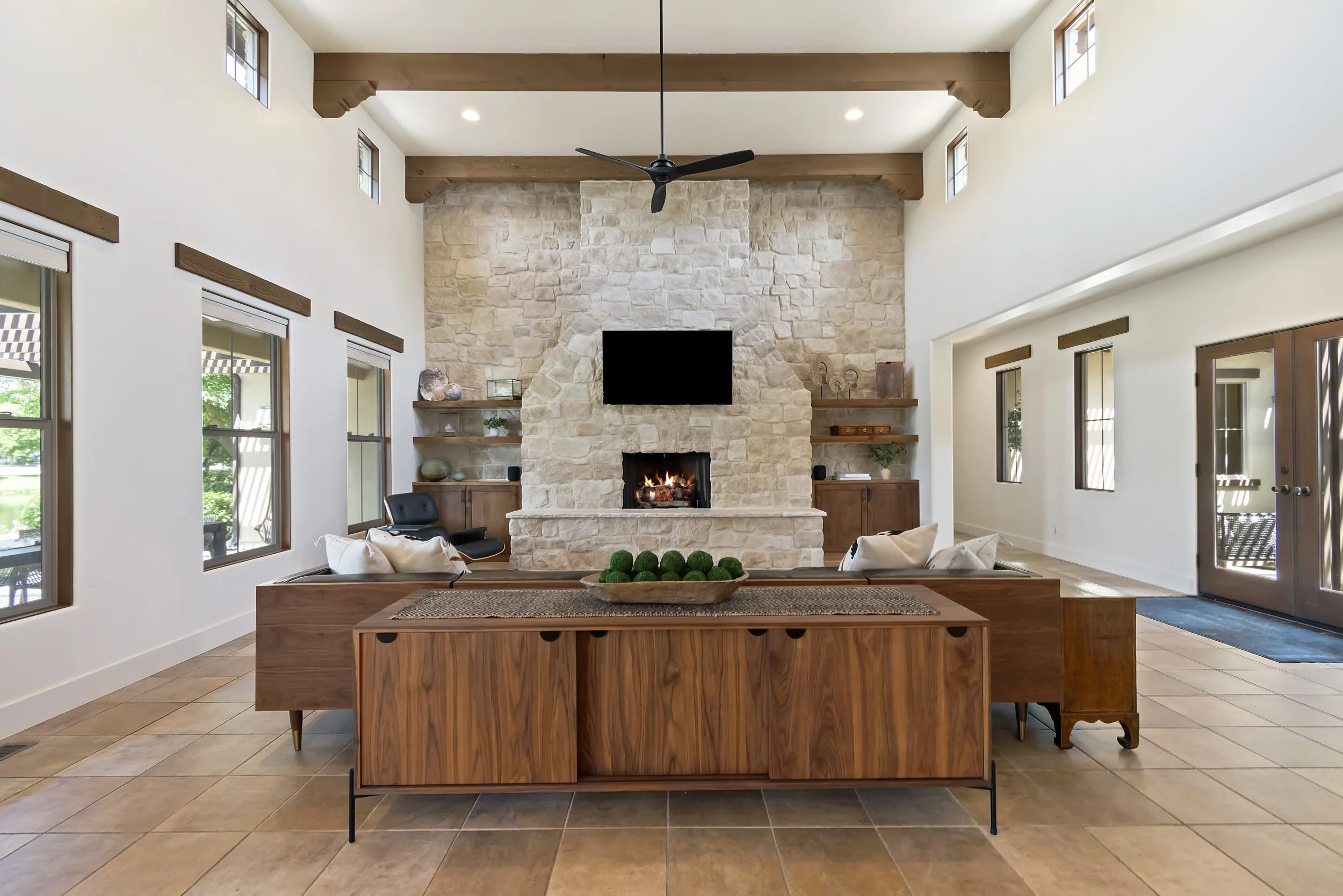 Vaulted great room with stone fireplace and wood beams in an Eagle, Idaho luxury home