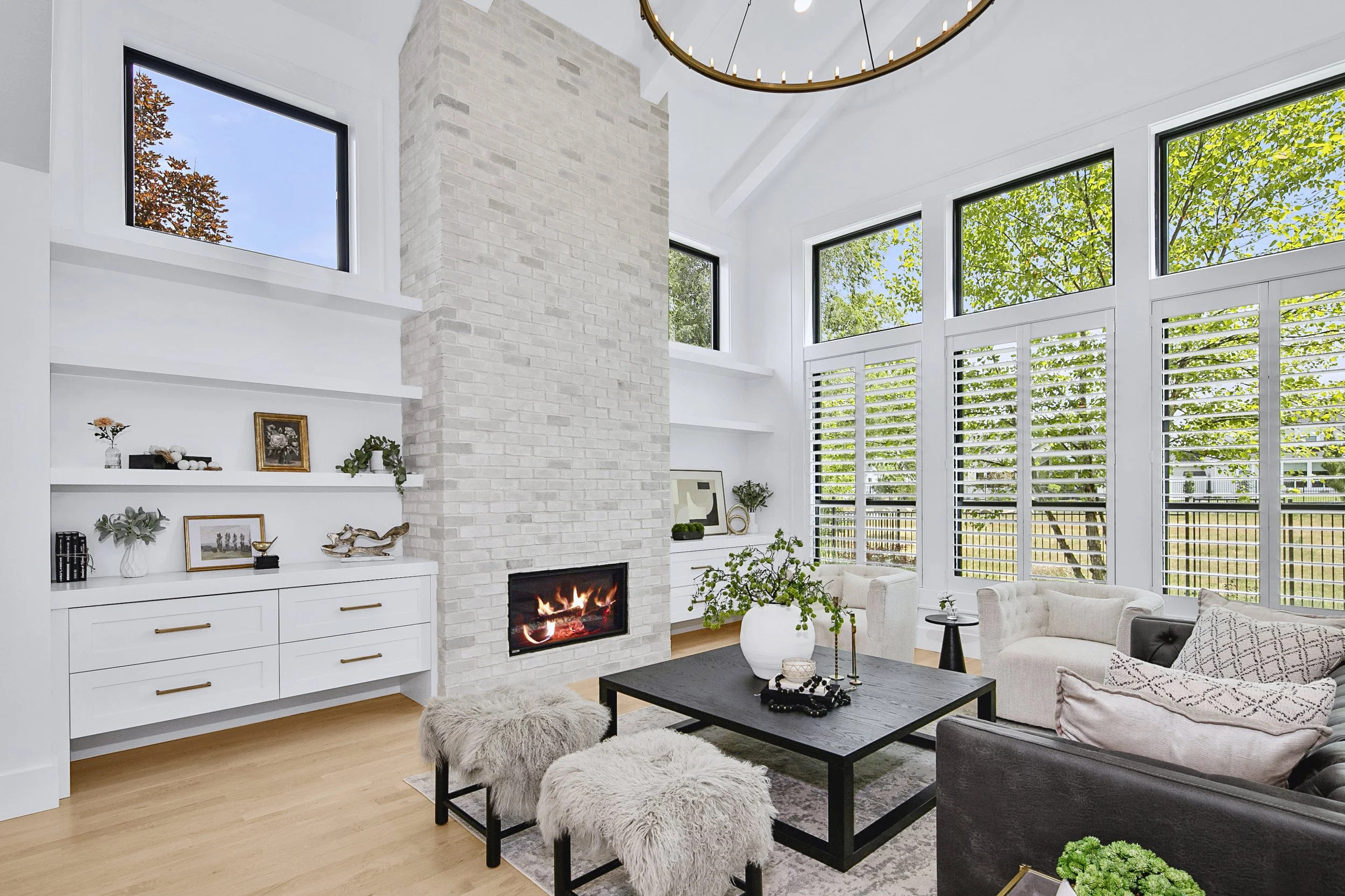 Bright living room with vaulted ceilings and stone fireplace in a Boise, Idaho luxury home