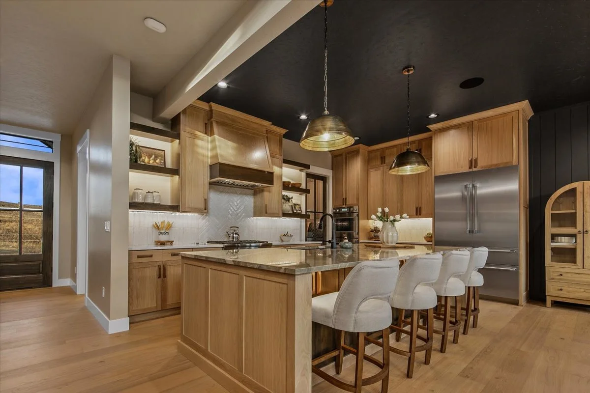 Chef's kitchen with quartzite island and Thermador appliances at 7017 N Cairnhill Way, Eagle, Idaho