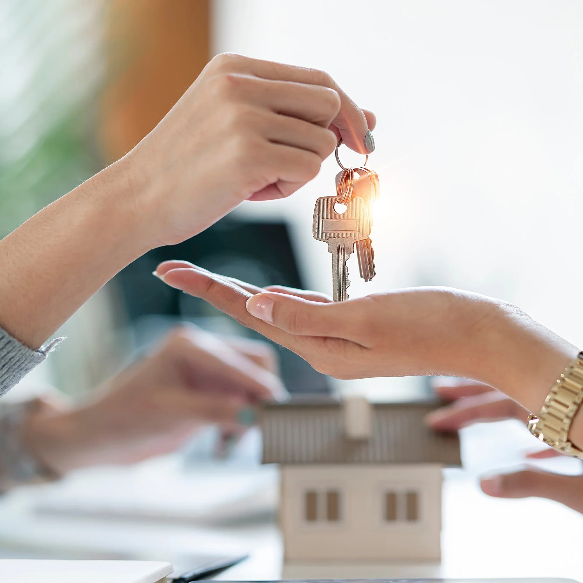 Real estate agent handing over house keys after a successful home sale in Eagle, Idaho
