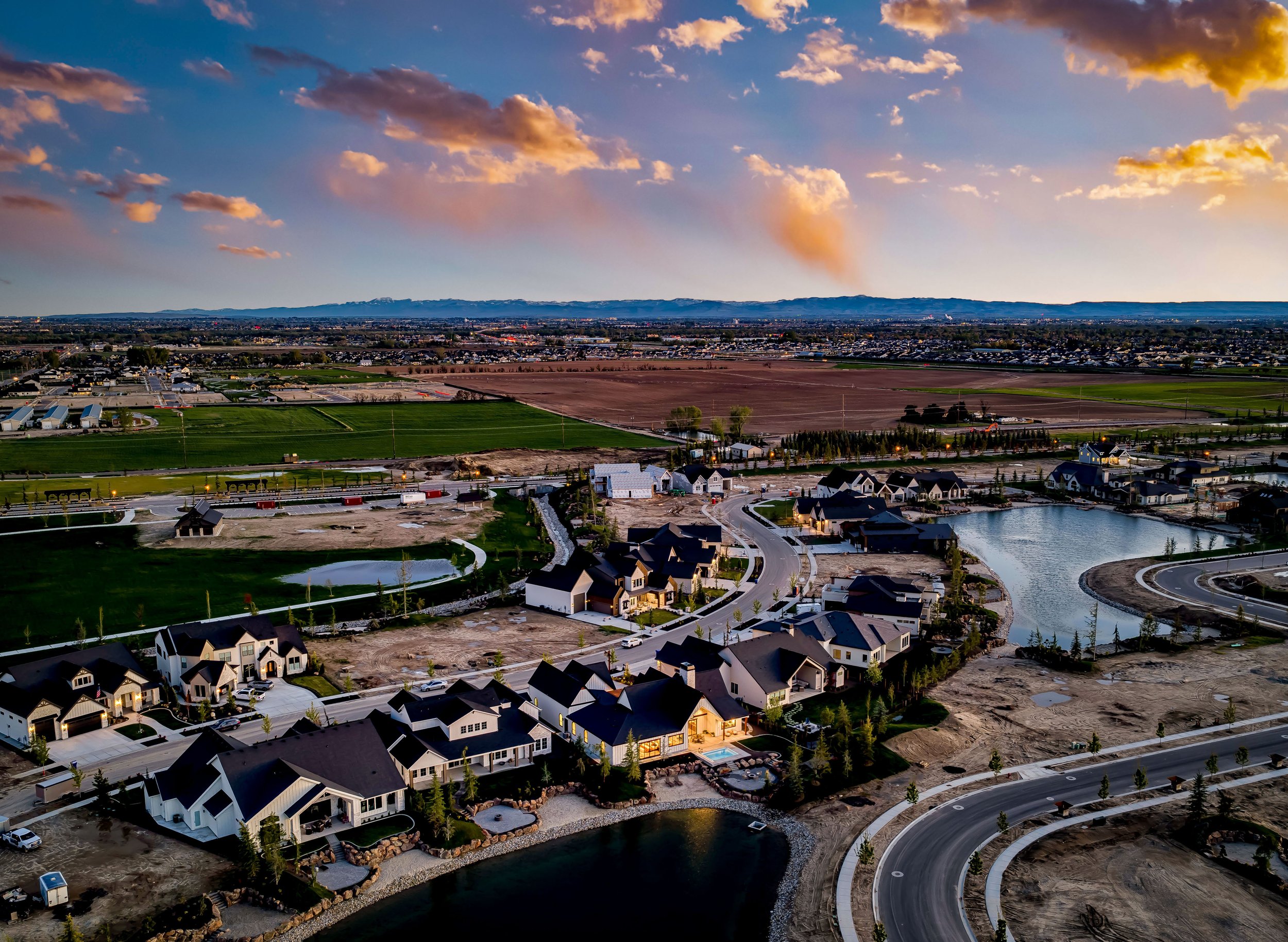 Aerial view of new waterfront homes and lakes in the Terra View community in Eagle, Idaho at sunset