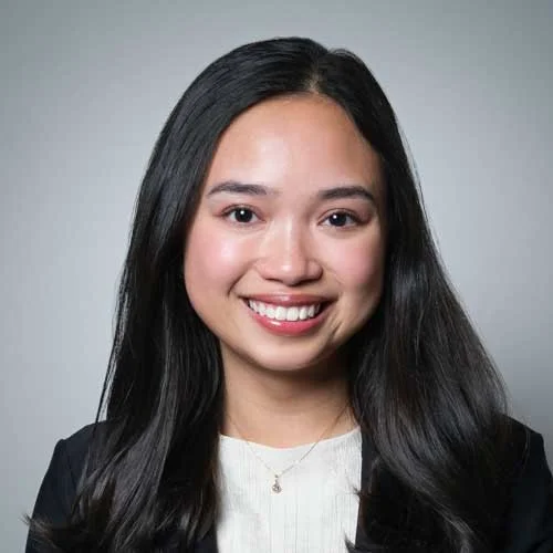 Headshot of female medical professional in Stamford, CT wearing a black blazer and white top, smiling for her ERAS application.