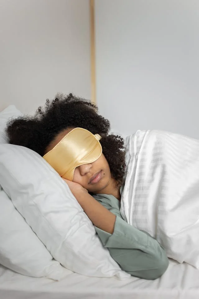 A woman sleeping with a sleep mask